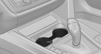 Storage tray for front cupholders