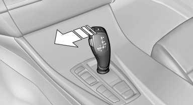 Push the selector lever to the left out of transmission